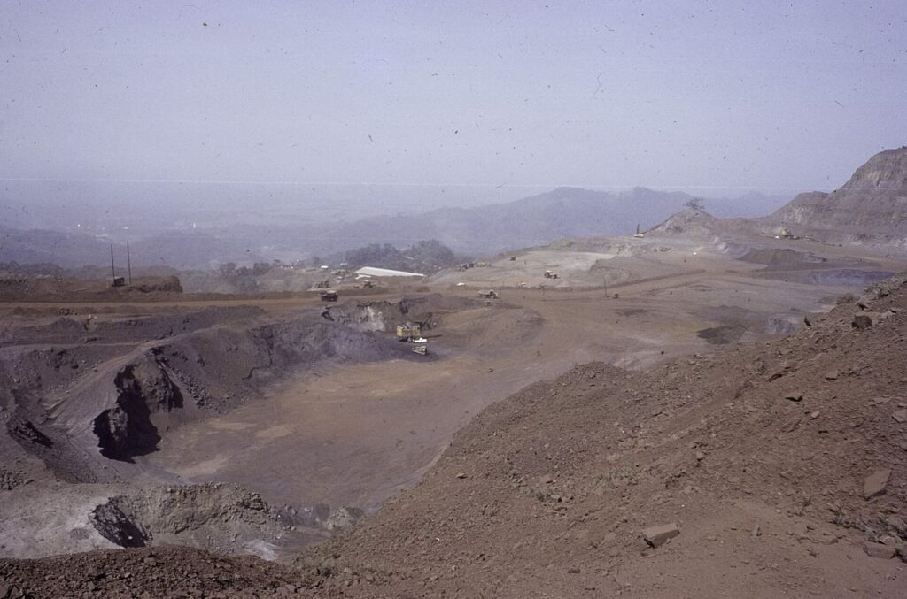 Open-pit mining trucks on a terraced mine in Africa